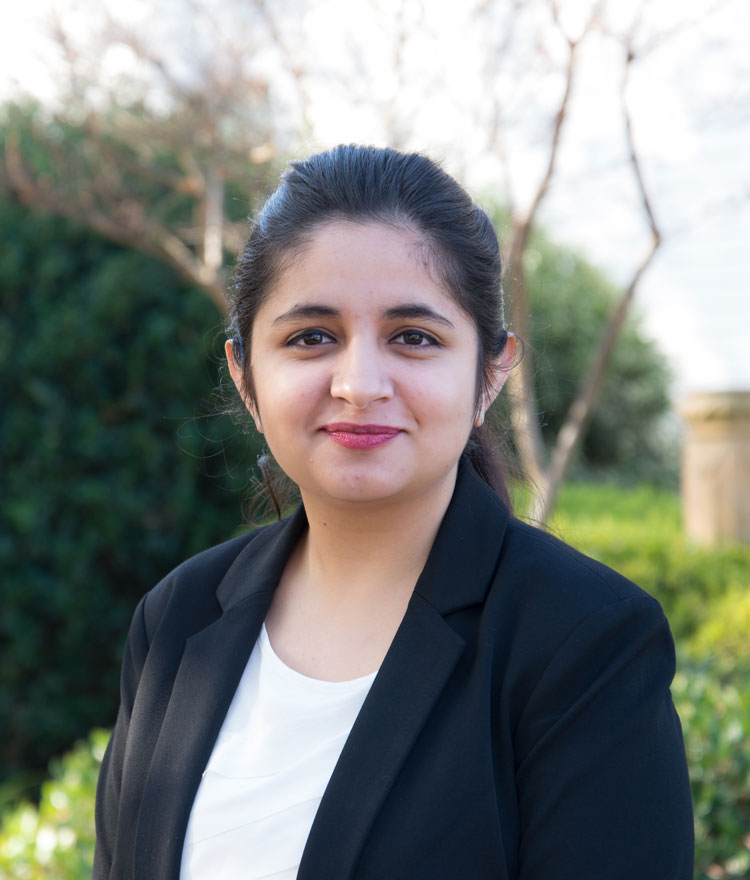 Student in a suit jacket outside