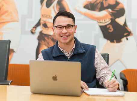 Student with a laptop and notepad