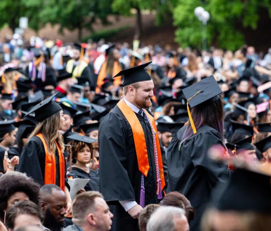 graduate standing in commencement crowd