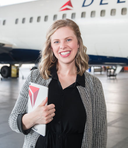 Allison Brantley in front of a Delta plane