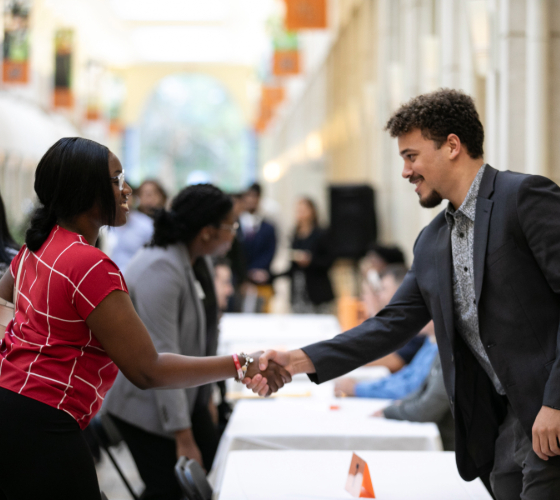 two people shaking hands in the University Center