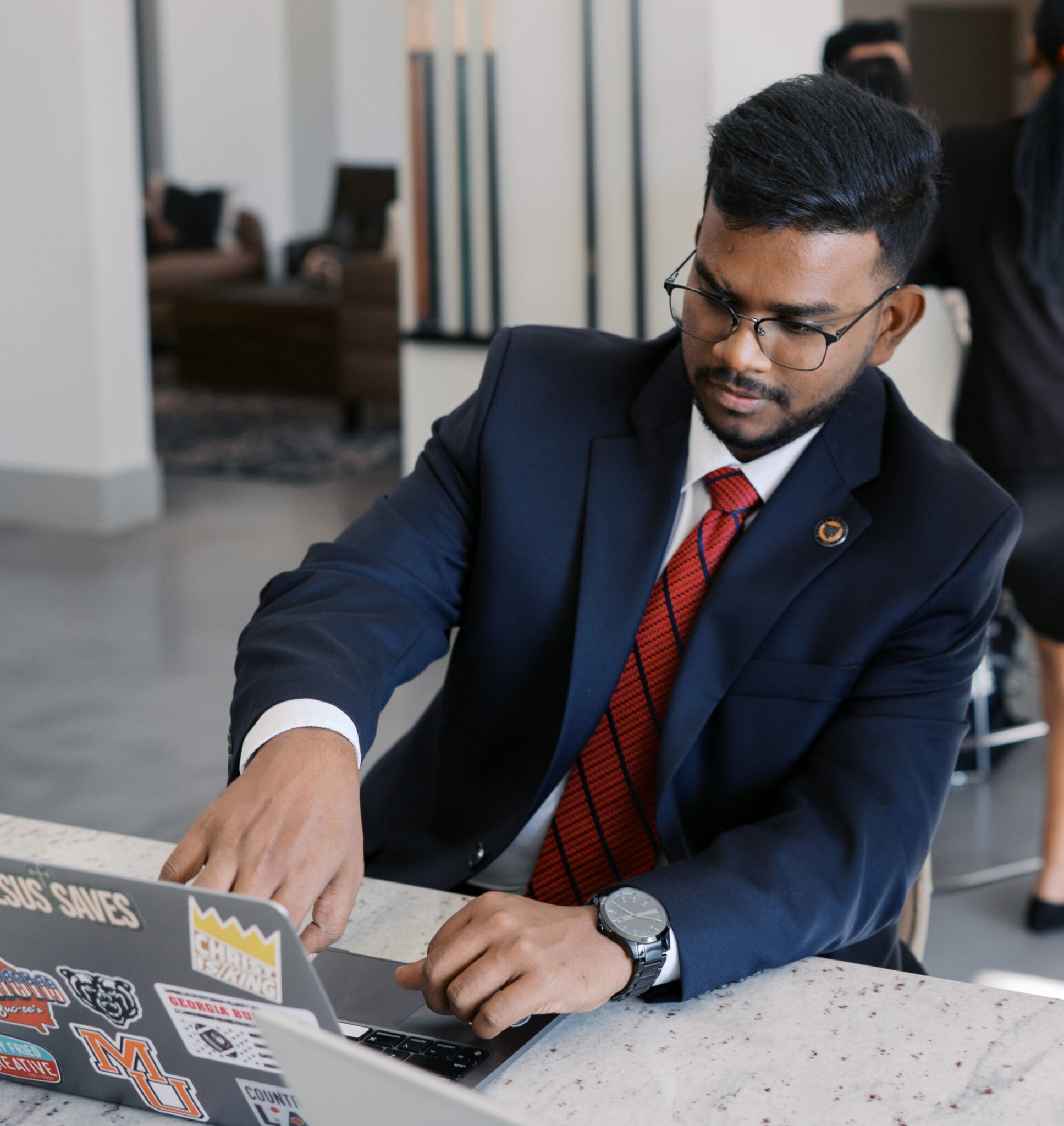 male business student pointing at a laptop