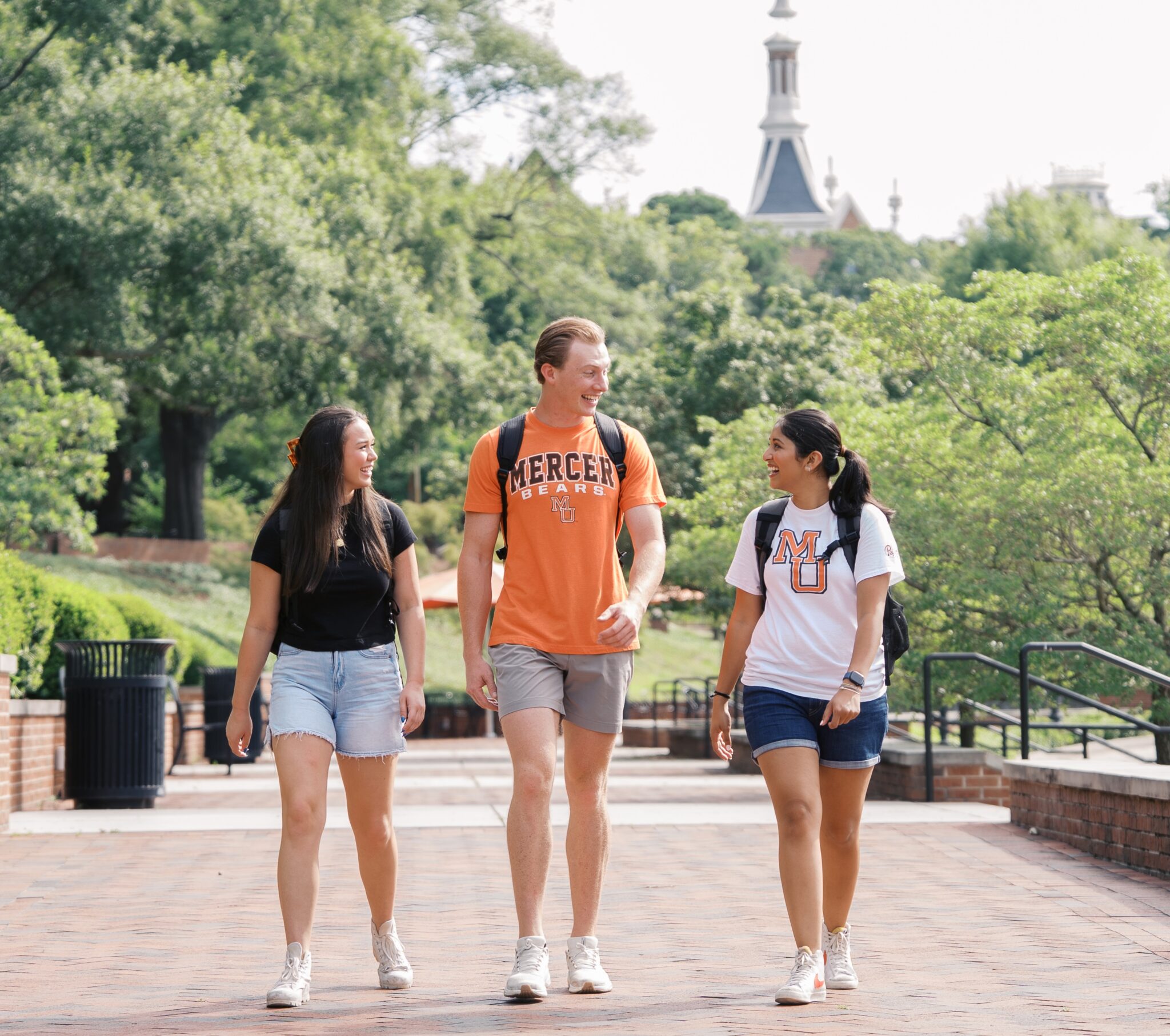 three students walking together and talking