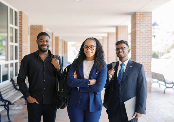 three students dressed in business professional wear
