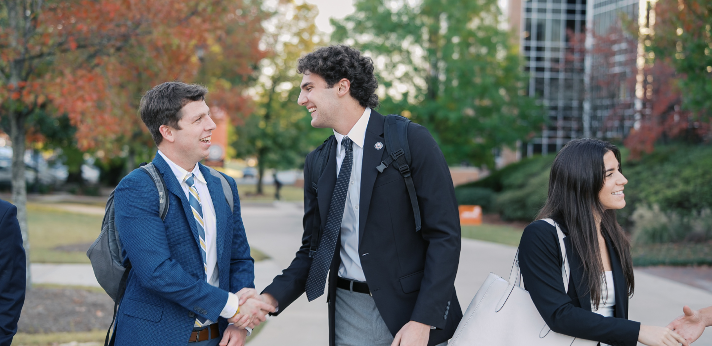 Business Students shaking hands